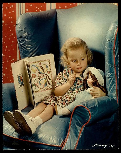Girl reading to her doll.1936.